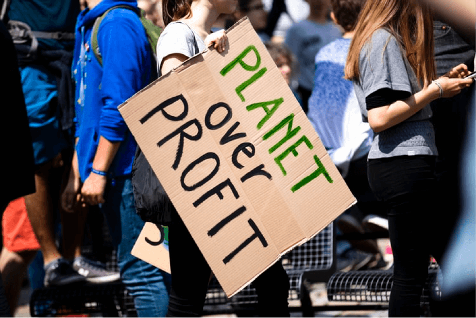 Planet over profit climate change protest sign