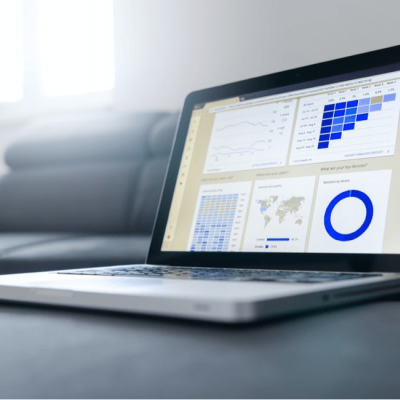 A laptop with customer data graphs on the screen